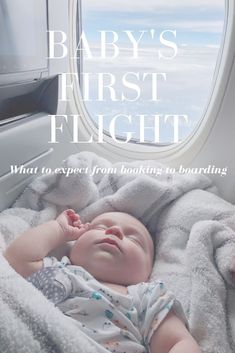 a baby laying on top of a blanket next to an airplane window with the words, baby's first flight