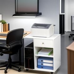 an office desk with a printer on it and a chair next to it in front of a monitor