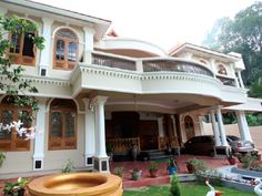 a large white house with lots of windows and balconies