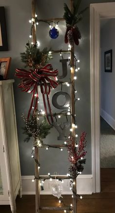 a ladder decorated with christmas decorations and lights