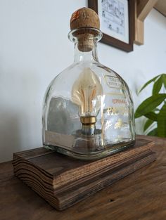 an old fashioned light bulb in a glass bottle