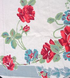 a white table cloth with red and blue flowers on it