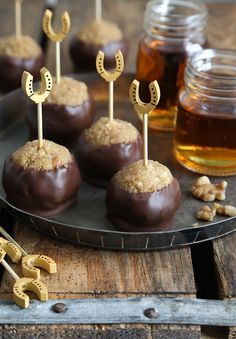 chocolate covered desserts with nuts and honey in the background