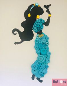 a woman with buttons in her hand and a black cat on the wall behind her