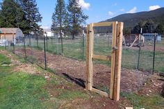 the fence is made out of wood and wire