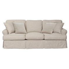 a white couch with four pillows on it's back and one arm folded down