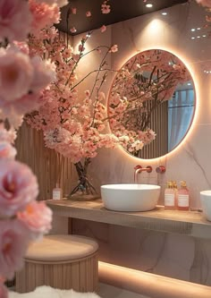 a bathroom with two sinks and a large mirror on the wall above it is decorated with pink flowers