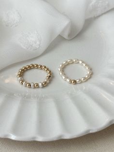 This beaded freshwater Pearl ring set adds elegance to your everyday jewelry look! Each dainty ring is hand beaded just for you! These gorgeous genuine Pearl rings are accented with sensitive skin safe 14K Gold Filled. * 3mm natural freshwater Pearls * 14K Gold Filled accent beads * Rings may be purchased as a set, or single from the drop down menu below. Extra Small ring fits US 4-5 Small ring fits US sizes 6-7 Medium ring fits US sizes 8-9 Large ring fits US sizes 10-11 See all Pearl Jewelry here!: https://etsy.me/3zMbXyh GET TO KNOW MAGBEE JEWELRY!: ✨ 🤍 All MagBee pieces are safe for sensitive skin and made with hypoallergenic Gold Filled or 925 Sterling Silver. 🤍 I only use real/natural gemstones and Pearls. 🤍 Most items are made to order just for you and have a 2-4 day processing t Stretch Rings, Beads Rings, Seed Pearl Ring, Gifts For Friend, Pearl Rings, Small Ring, Freshwater Pearl Ring, Ring Gifts, Zierlicher Ring