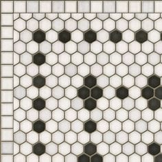 a white and black tiled wall with hexagonal tiles