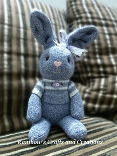 a blue stuffed animal sitting on top of a couch