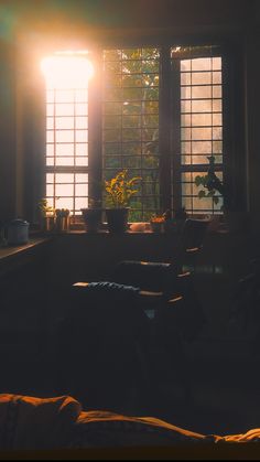 the sun shines through two windows in a dark room