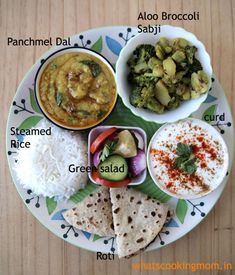 a plate with different types of food on it, including rice and broccoli