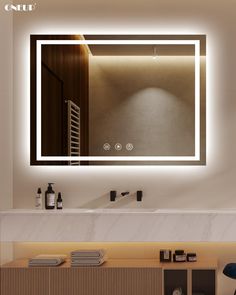 a bathroom with a large mirror and lights on the wall above it, next to a sink