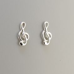 For the musician in your life, these lovely treble clef earrings are the perfect gift.  Made in 925 sterling silver, they are a delightful adornment bringing music to your ears All our items are delivered in a presentation box and  are sent using the French postal service "La Poste"  with tracking. You will receive an email when it is shipped.  ♥ Please like our Facebook page to see our new products and photos! CARING FOR STERLING SILVER  Sterling silver with time develops a patina which often e Music Note Earrings, Cheap Music-themed Earrings For Pierced Ears, Silver Heart-shaped Music-themed Jewelry, Music-themed Silver Earrings, Music-themed Sterling Silver Necklace, Silver Nickel-free Music-themed Earrings, Treble Clef, Music Lovers, Solid 925 Sterling Silver