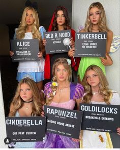 the girls are holding up signs that read red r hod, tinkerbell, raunzel, and goldiloks