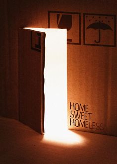 an open door with the light shining through it in front of a sign that reads home sweet homeless