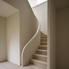 an empty room with a staircase and skylight