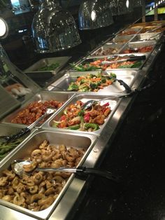 a buffet line filled with different types of food