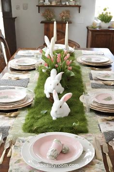 a table set for easter with bunny decorations