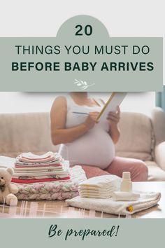 a pregnant woman sitting on the floor next to her stack of blankets and baby clothes