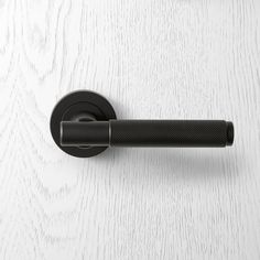 a black handle on a white door