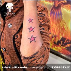 a woman's arm with three stars on it