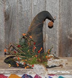 an old witch's hat is sitting on a table next to a piece of cloth