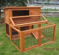 a large wooden rabbit hut sitting in the grass