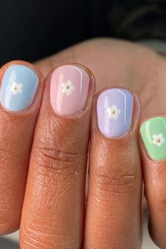 Get ready to fall in love with these charming Pastel Rainbow Short Squoval Nails! 🌈💅 Delicately painted in an array of baby blue, soft pink, lavender, and mint green, these nails will add a touch of sweetness to any look. The petite white flower accents with golden centers make them even more adorable. Click through to see more of this irresistible nail art! // Photo Credit: Instagram @nailedbyrebeka Cute Easter Nails, Pastel Nail Art, Pastel Nails Designs, Pastel Nail, Squoval Nails