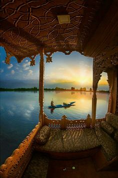 a person in a boat on the water at sunset