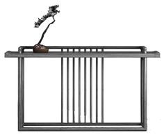 a metal table with a plant on top and bars in the bottom, against a white background