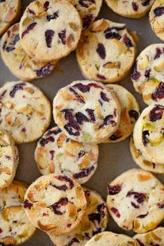 many small muffins with different toppings on a baking sheet, top view