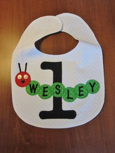 a bib with the number one on it and a ladybug in the middle