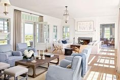 a living room filled with lots of furniture next to a fire place in a house