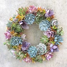 a wreath made out of succulents on the ground