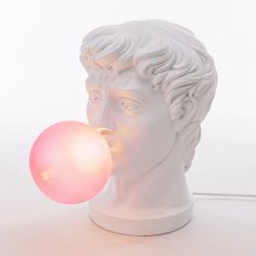 a white bust with a bubble coming out of it's mouth