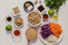 the ingredients are laid out on the table to be prepared for this meal, including carrots, rice, and beans