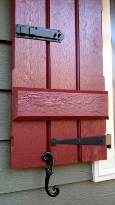 a red door with an iron hook on it