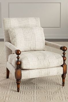 a white chair sitting on top of a carpeted floor next to a wooden frame