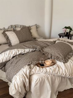 a bed with white sheets and brown pillows