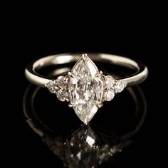 an old cut diamond ring with three stone accents