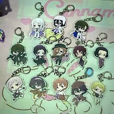 an assortment of anime keychains on a table