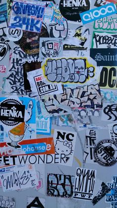 many different stickers and decals on a wall