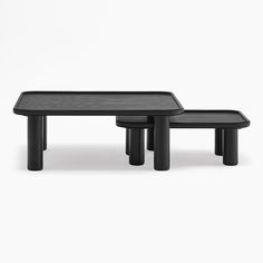 two black tables sitting next to each other on top of a white surface with no one in it