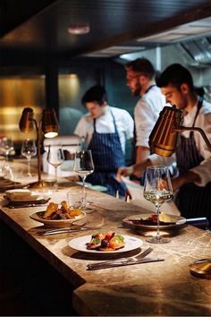 the chefs are preparing their meals in the restaurant kitchen together, ready to be served