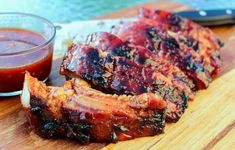 barbecue ribs and sauce on a cutting board