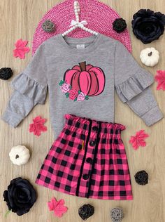 Carve out some cuteness with this chic pink plaid skirt set. Utterly adorable with a cozy ruffle sweatshirt, your precious pumpkin will want to wear it all season long! Sensible for casual and dressy occasions Flattering, fashionable, and fun for playdates Perfect for fall, Thanksgiving, school, birthday parties, and pumpkin patches Long-sleeve pullover top with pumpkin graphic print, ruffle sleeve details, and faux button plaid skirt Set available in sizes 2T-10Y for toddlers and girls Pink Plaid Skirt, Plaid Skirt Set, Toddler Flower Girls, Girls Dress Outfits, Pink Checkered, Toddler Flower Girl Dresses, Infant Flower Girl Dress, Checkered Skirt