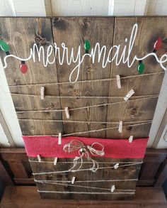 a wooden sign that says merry mail with string lights attached to the front and side