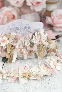 a close up of a box with flowers on it next to some pink and white roses