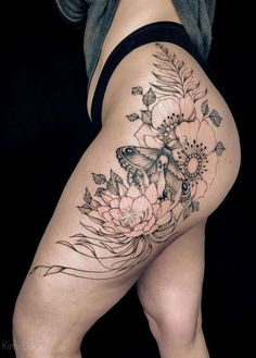 a woman's thigh with flowers and a butterfly on it